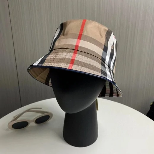 Bucket hat in a beige, black and red check pattern on a black mannequin head