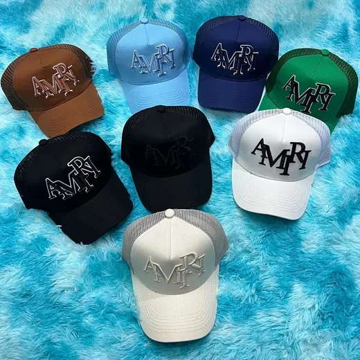 Several trucker caps with raised embroidered lettering spread over blue faux fur