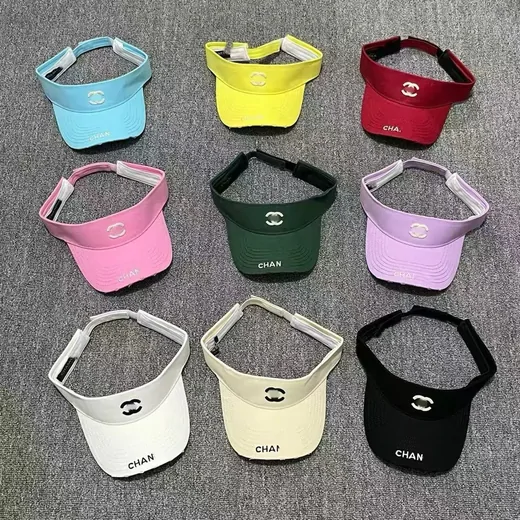 Nine sun visors laid out in three lines of pastel and bright colours