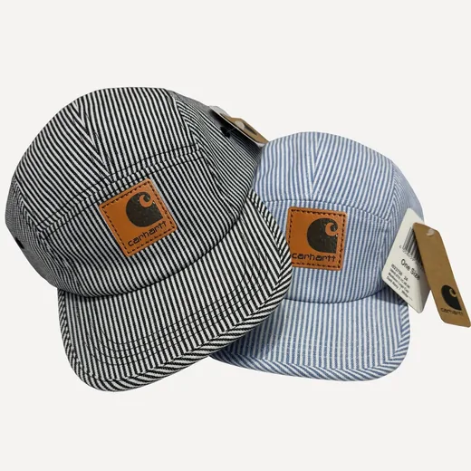 Two striped work caps, one grey and one pale blue, each with a brown patch and a paper tag