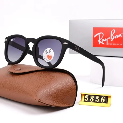 Black rounded sunglasses with grey gradient lenses beside a tan leather-look case