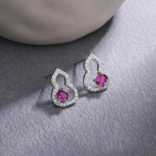 Pair of silver-tone stud earrings with pink stones and a halo of small clear stones