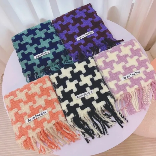 Four fringed scarves with a large houndstooth pattern in teal, purple, orange, black and lilac