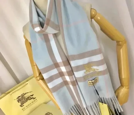 Pale blue and beige check scarf hanging on a display stand