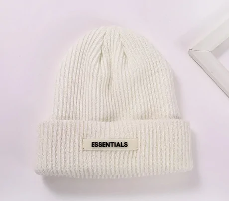 White rib knit beanie with a small woven label on the cuff