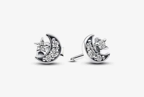 Pair of silver-tone moon and star stud earrings on a white background