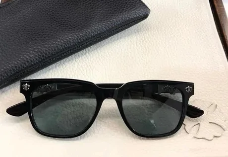 Black rectangular sunglasses in front of a black hard case