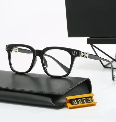 Black square glasses frame resting on a black case