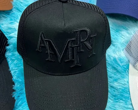 Black trucker cap with tall raised lettering on blue faux fur