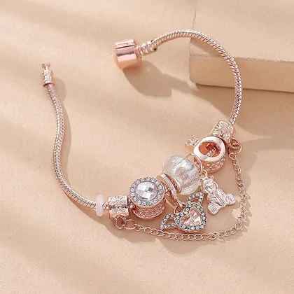 Rose-gold snake-chain charm bracelet with beads and pendants