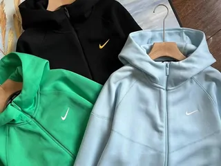 Black, green and pale blue zip-up hooded sweatshirts