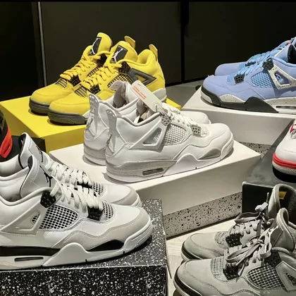 Pile of high-top sneakers in white, grey, yellow and black