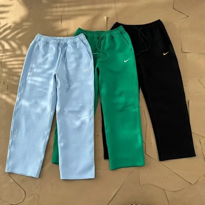 Light blue and bright green sweatpants laid side by side